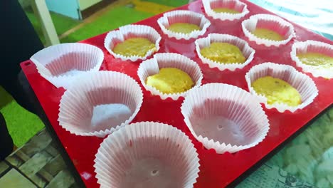 Pouring-cup-cakes-mixture-and-preparing-for-baking