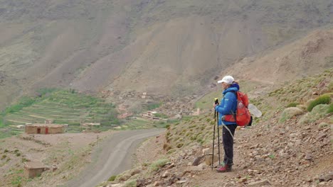 Tourist-watching-Tacheddirt-valley-in-High-Atlas-mountains,-Morocco