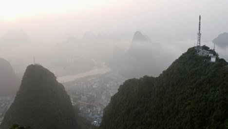 4k-drone-through-mountains-around-Tv-Tower-above-the-misty-clouds-guilin