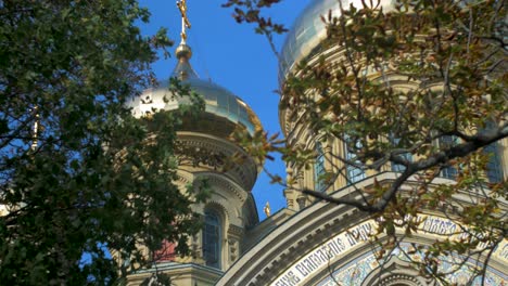 View-of-orthodox-St-Nicholas-Naval-Cathedral-golden-domes-and-crosses-on-blue-sky-in-sunny-autumn-day-at-Karosta,-Liepaja,-tilt-up-medium-shot