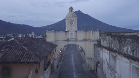 A-rising-drone-shot-of-'Arco-de-Santa-Catalina',-Santa-Catalina-Arch,-in-Antigua,-Guatemala