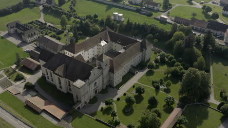 Abbey-seen-from-above,-surrounded-by-vegetation-and-trees