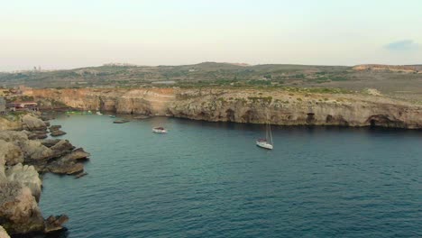 Majestic-aerial-view-of-the-cliffs-surrounding-the-lagoon-with-old-movie-set
