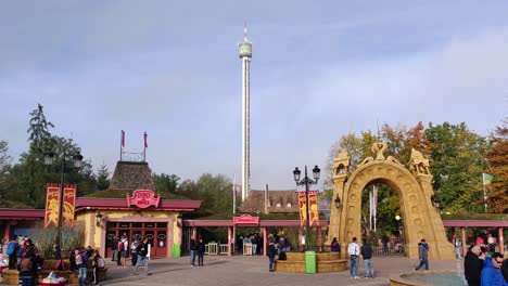People-having-fun-at-Holiday-Park-Hassloch,-Germany,-while-an-Anubis-Free-Fall-Tower-is-riding