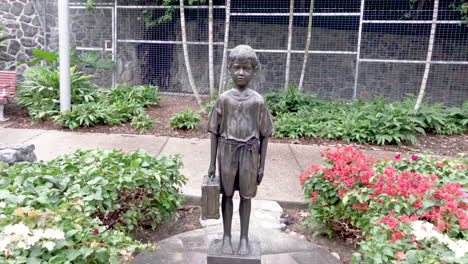 Indigenous-young-boy-statue-in-colourful-gardens