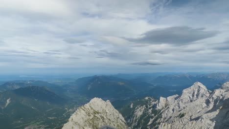 Panorama-from-Zugspitze-mountain-peak-over-Apls,-moving-forward-shot