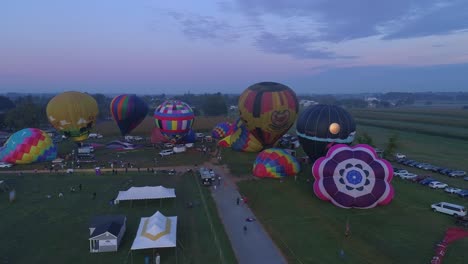 Aerial-View-of-a-Morning-Launch-of-Hot-Air-Balloons-at-a-Balloon-Festival-from-Filling-up-to-Take-Off-as-Seen-by-a-Drone