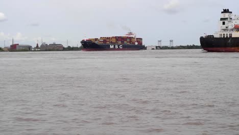 Cargo-ships-moving-down-the-Mississippi-River-at-New-Orleans,-Lousiana