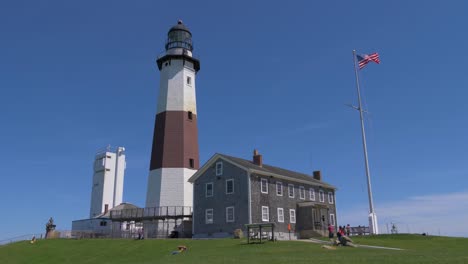 Establishing-shot-of-Montauk-Point-Lighthouse-Museum-under-renovation-on-a-sunny-summer-day,-June-2019