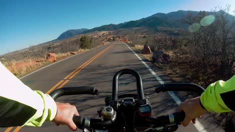 Cyclist-riding-downhill-on-Colorado-roads,-camera-point-of-view