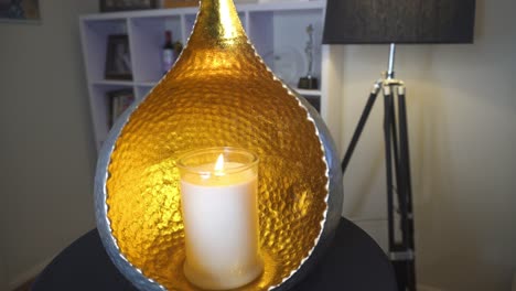 Orb-candle-holder-with-flickering-candle-slow-pan-in-living-room,-Calming