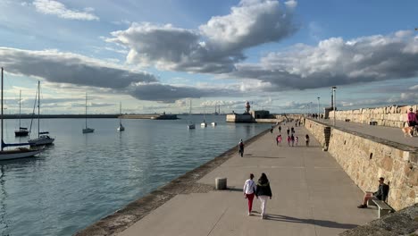 Families-and-tourists-walking-along-the-pier-at-Dublin-harbor-on-a-beautiful-sunny-day
