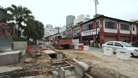 Wide-Angle-View-of-construction-works-of-upgrading-sewerage-system-in-middle-of-town-road-during-overcast-day