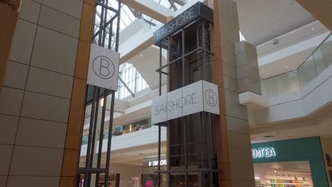 Bayshore-Mall-Glass-Elevators-Cinematic-Side-View-in-Ottawa,-Canada