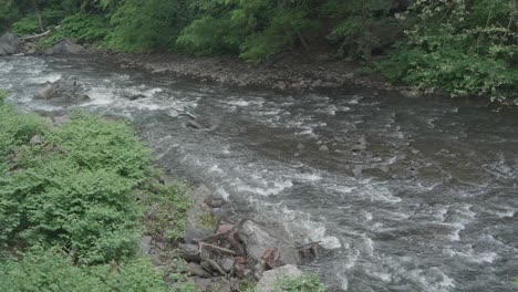 The-Wissahickon-Creek,-high-angle,-flowing-over-rocks-and-stones
