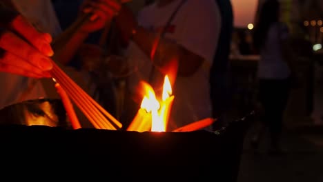 Persons-Lighting-Candles-As-A-Religious-Beliefs-Of-The-Buddhism-Tradition---Close-Up-Shot