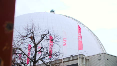 Low-slide-of-Stockholm-Globe-Arena-from-afar,-close-up-of-dome