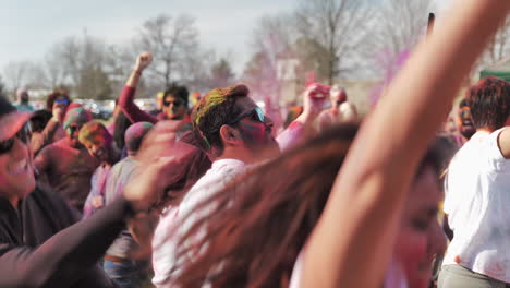 Man-dancing-in-crowd-of-people-at-Holi-Festival-takes-selfie-with-phone
