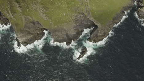 Slow-cinematic-aerial-panning-shot-of-the-North-Atlantic-ocean-breaking-against-the-northern-Irish-coast