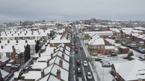 Aerial-view-heavy-traffic-on-Anchor-road-Longton,-a-sudden-snow-blizzard-in-Stoke-on-Trent,-dangerous-driving-conditions,-cars-travelling-slowly,-safely,-West-Midlands