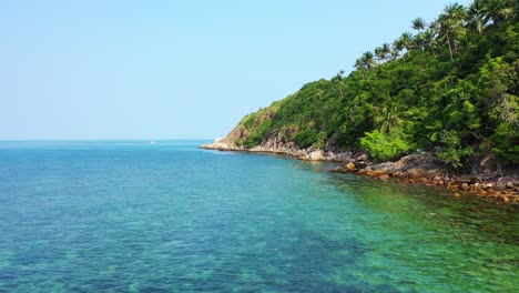 Wild-rocky-shore,tropical-island-with-crystal-clear-water-exotic-vegetation
