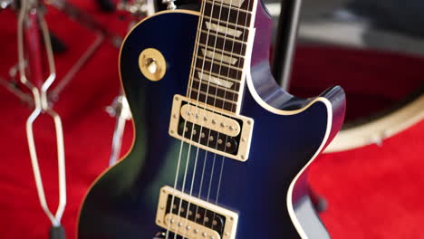 A-vintage-blue-electric-guitar-on-a-concert-stage-in-a-rock-and-roll-garage-band-setting