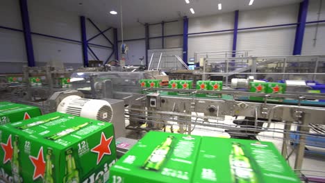 Pan-shot-of-beer-packages-moving-inside-the-Heineken-brewery-facility