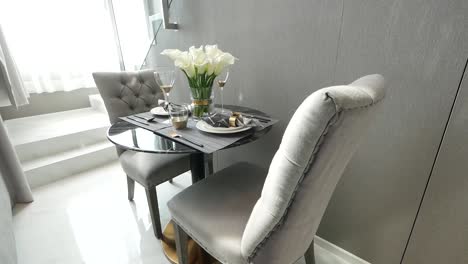 Decorated-Rounded-Glass-Coffee-table-with-Elegant-Silver-Chairs