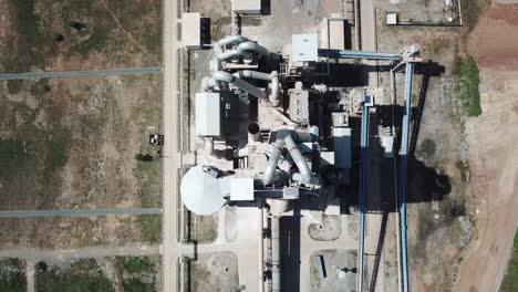 Big-Metal-Equipment-Used-In-Cement-Manufacturing-Inside-A-Cement-Factory---Aerial-Shot