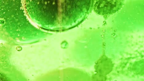 Makroaufnahme-Großer-Und-Kleiner-Grüner-Blasen,-Die-In-Hellgrünem-Wasser-Schwimmen-Und-Tropfen