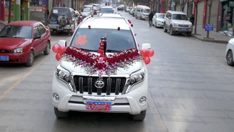 A-beautiful-white-limousine-perfectly-designed-and-decorated-for-a-traditional-wedding-in-Weixi,-Yunnan---Slow-motion
