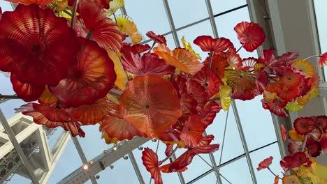 Looking-up-at-the-beautiful-glass-art-made-by-world-famous-artist-Dale-Chihuly-with-the-Seattle-Space-Needle-in-the-background