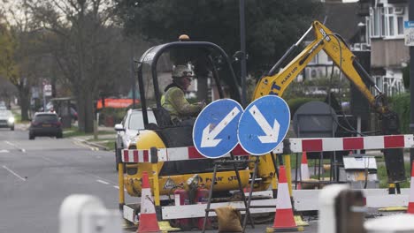 Mini-JCB-Digging-Up-Road-To-Replace-Gas-Pipes-In-London