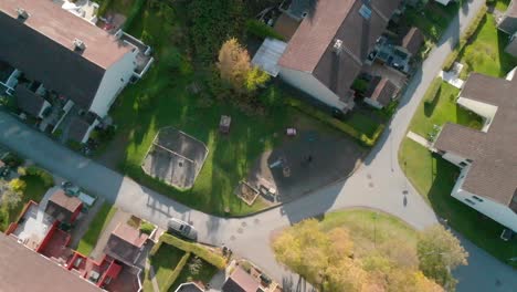Looking-down-over-suburbia,-houses-and-backyards