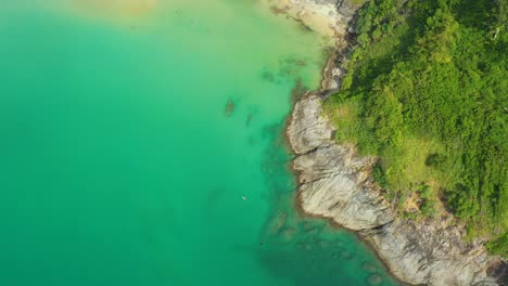 Aerial-High-angle-view-of-people-enjoy-swimming-and-relax-on-the-beach-in-Phuket-Thailand-Patong-beach-is-a-very-famous-tourist-destination-in-Phuket-4k-aerial-view-Drone-top-down-Beautiful-beach