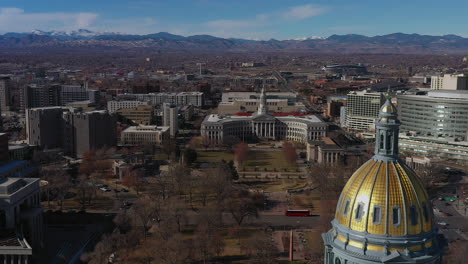 Aerial-drone-footage-over-the-State-Capitol-government-Building,-with-a-view-of-Capitol-city-park,-in-Downtown-Denver,-Colorado