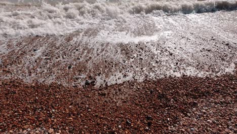 Close-up-of-smooth-waves-at-pebble-beach-in-Pevensey-in-south-England