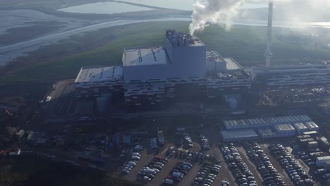 Aerial-view-of-K3-Kemsley-power-station-in-Kent,-UK-with-a-reveal-from-the-steam-similar-to-a-fade-from-white