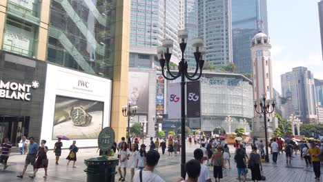 Crowds-of-chinese-citizens-walking-on-a-square-among-new-modern-highrise-commercial-buildings-In-shopping-city-centre