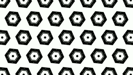 Animation-of-monochromatic-hexagons-arranged-symmetrically-in-rows-and-rotating,-on-white-background