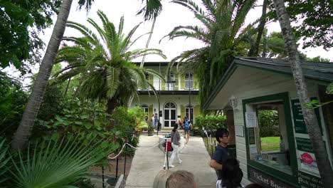 Hemingway-House-Museum-in-Key-West,-Florida-With-Tourists-at-Ticket-Booth-Wide