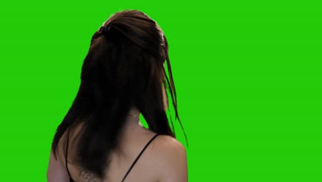 Pretty-brunette-woman-seductively-winks-and-walks-away-on-green-screen