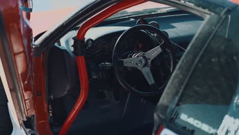 Slow-motion-detail-shot-of-the-steering-wheel-in-a-modified-race-car-interior