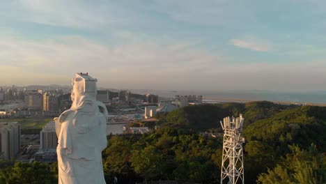 Aerial-rotating-around-famous-A-Ma-Statue-in-Coloane,-Macau