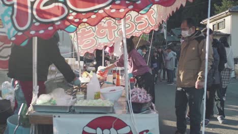 Yatai-Food-Vendor-Preparing-Delicious-Food-And-Snacks-For-Customers-During-The-Teppo-Matsuri-Festival-In-Chichibu,-Tokyo,-Japan