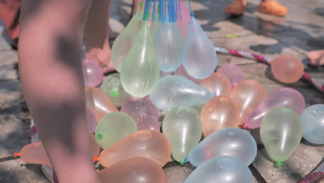 Colorful-water-balloons-being-filled-up