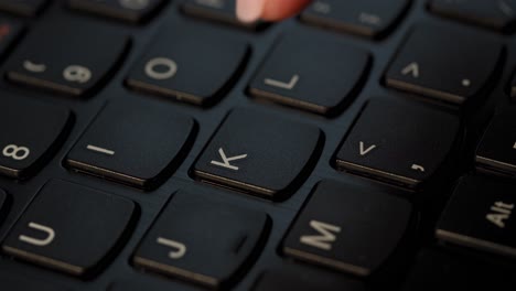 Pushing-K-button-on-the-black-keyboard