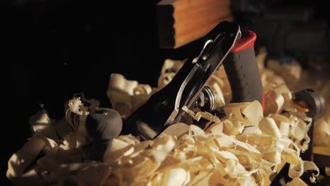 Placing-hand-plane-down-on-shavings-dramatic-wind-impact-Slow-motion