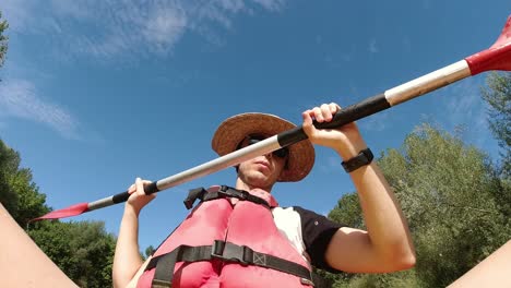 Funny-clip-of-young-man-paddling-kayak-along-the-river