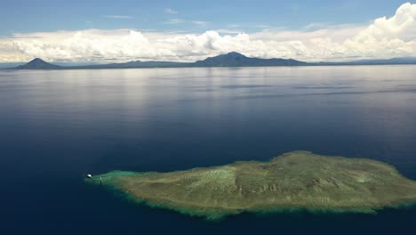 Aerial-shot-of-a-small-island-in-the-middle-of-the-ocean
